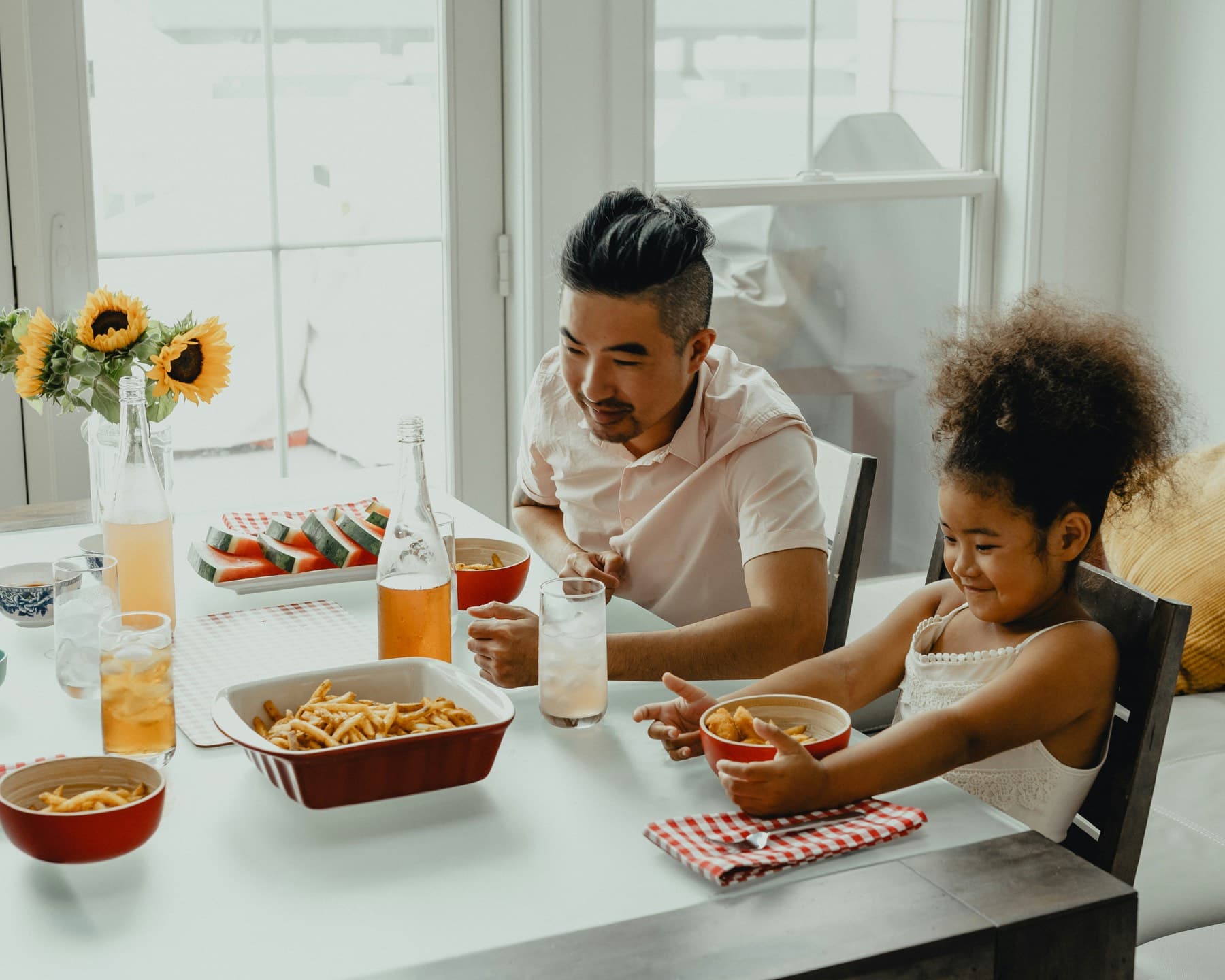 A boy and a girl eating at a table